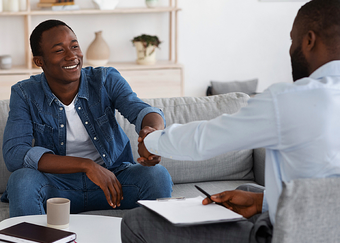 Male patient shaking hands with his therapist