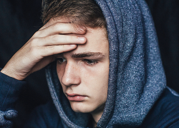 Male holding his forehead thinking something